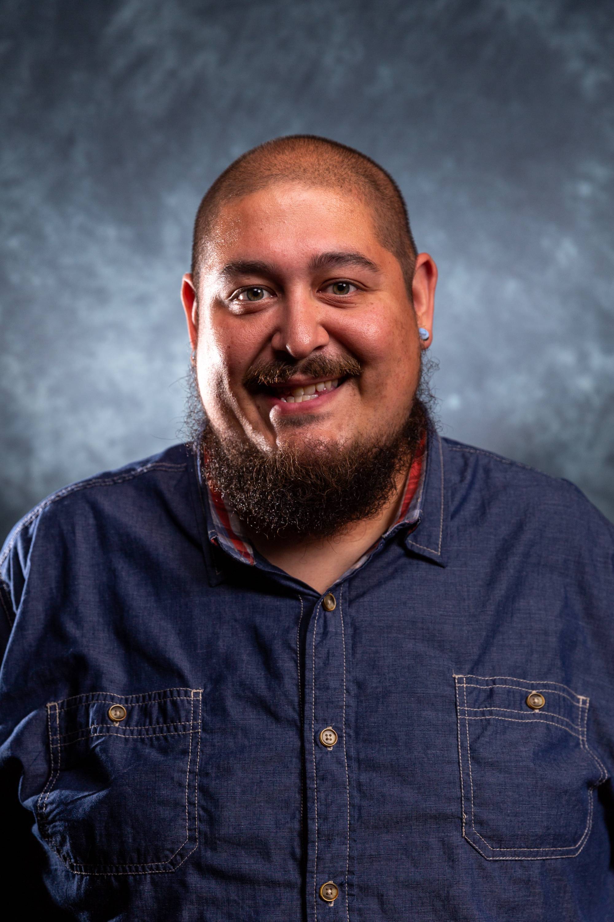 Santiago Gayton sample head shot in front of light blue background